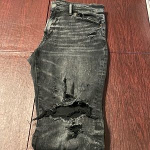 Black destroyed [AE] jeans.